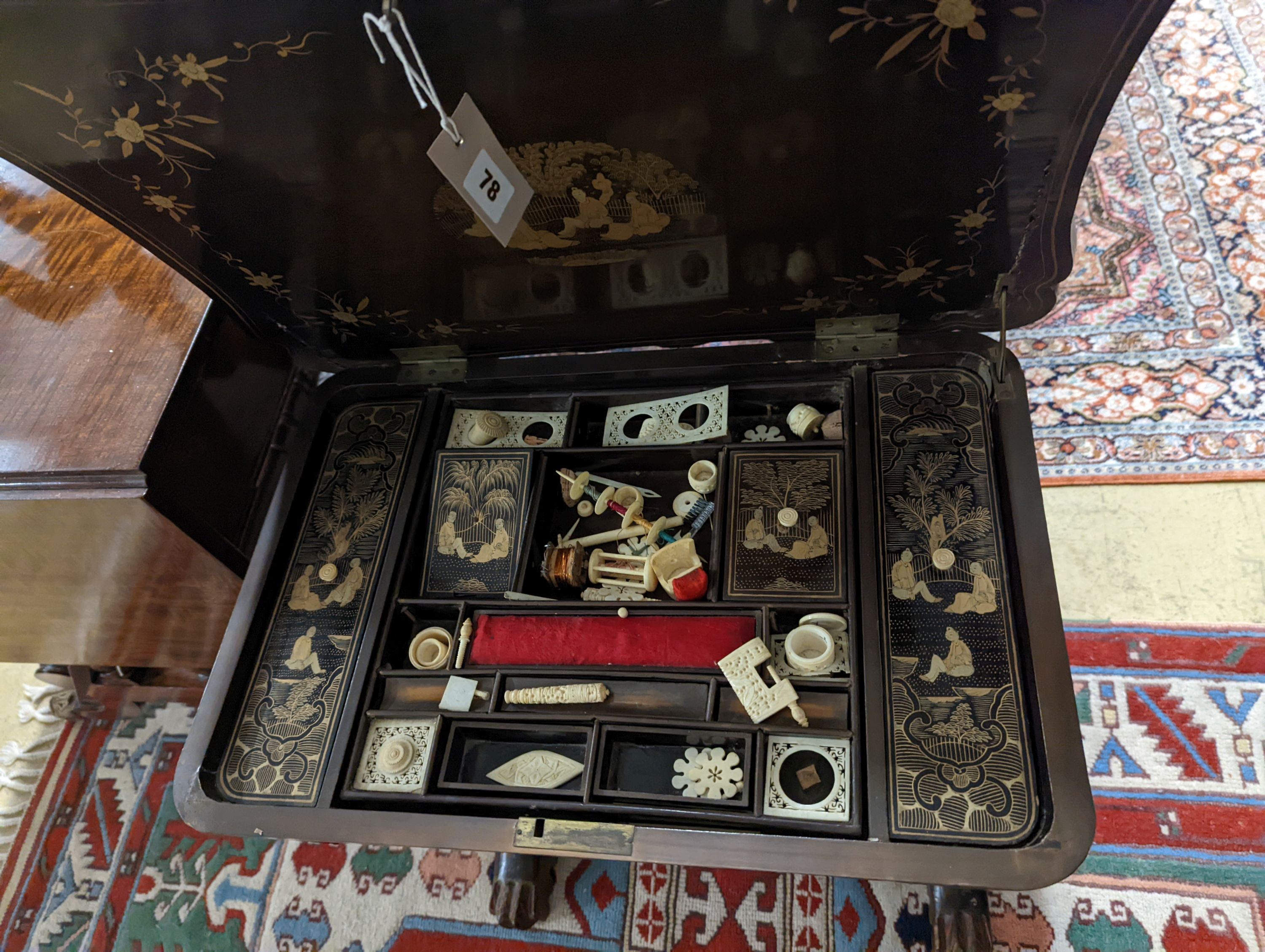 A mid 19th century Chinese export lacquer work table. W-59cm,D-41cm, H-66cm., containing bone accessories